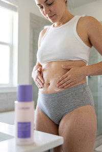 Applying the belly firming cream in circular motions