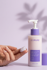 Cream dispensed onto fingertips beside the bottle